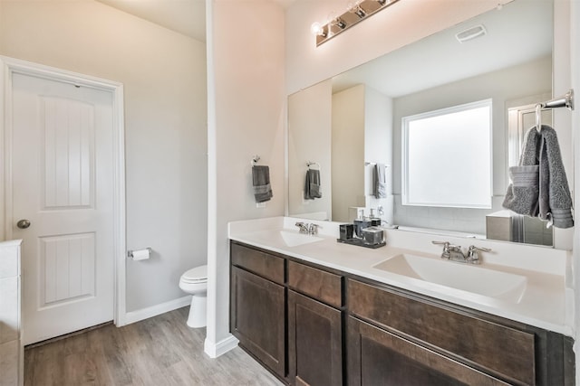 bathroom featuring hardwood / wood-style floors, vanity, and toilet