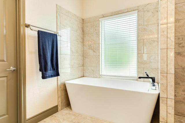 14 Augusta Ln, West Columbia, TX 77486 - bathroom with a freestanding bath and healthy amount of natural light