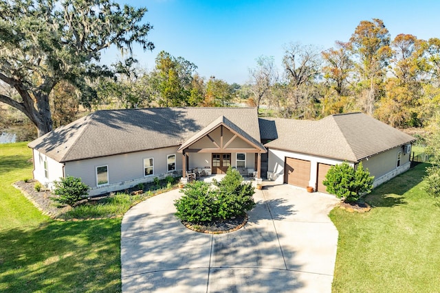 ranch-style home featuring a garage and a front yard