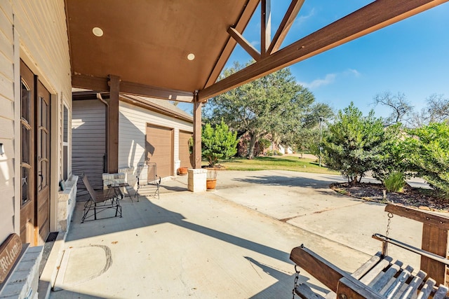 view of patio / terrace featuring a garage