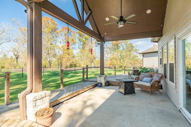 view of patio / terrace featuring a fire pit, ceiling fan, and a deck