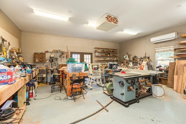 interior space with a workshop area and a wall mounted AC