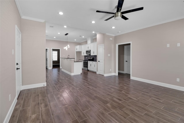 unfurnished living room featuring dark hardwood / wood-style floors, ceiling fan, and crown molding