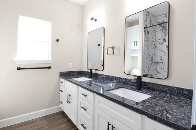 bathroom with a shower, hardwood / wood-style floors, and vanity