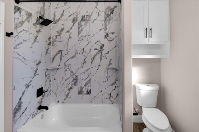 bathroom featuring toilet and tiled shower / bath