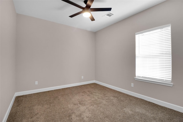 carpeted empty room featuring ceiling fan