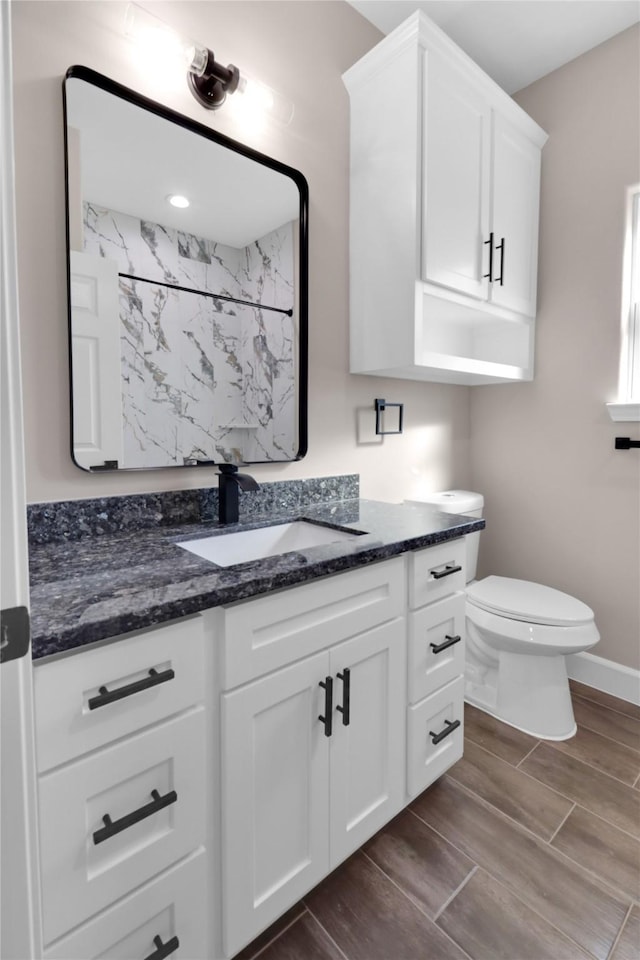 bathroom with vanity, toilet, and walk in shower