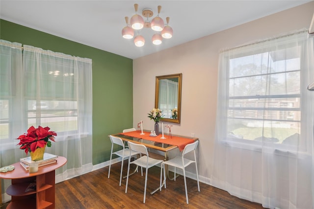 dining area featuring a chandelier and dark wood-type flooring