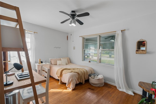 bedroom with hardwood / wood-style floors and ceiling fan