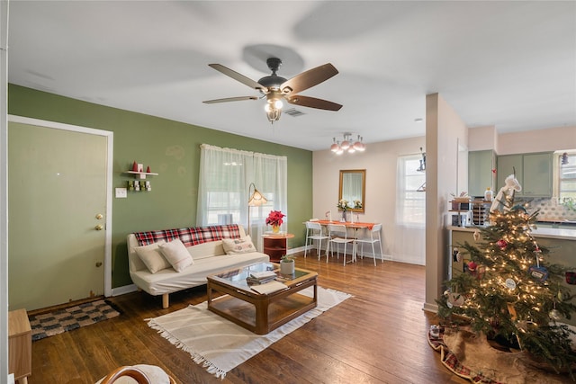 living room featuring ceiling fan and dark hardwood / wood-style floors