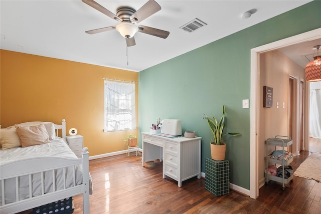 bedroom with ceiling fan and dark hardwood / wood-style floors