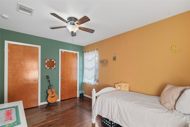 bedroom with dark hardwood / wood-style floors and ceiling fan