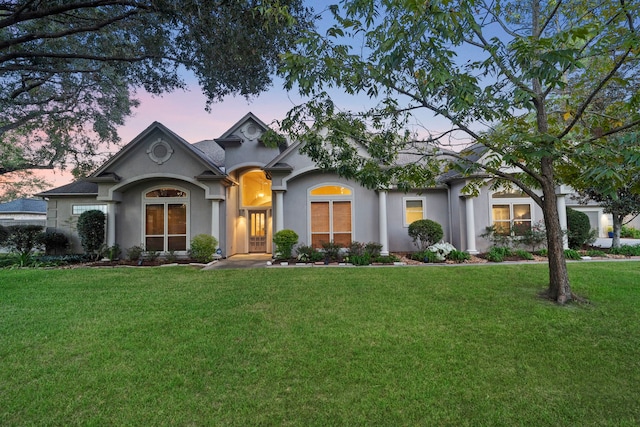 view of front of property with a lawn