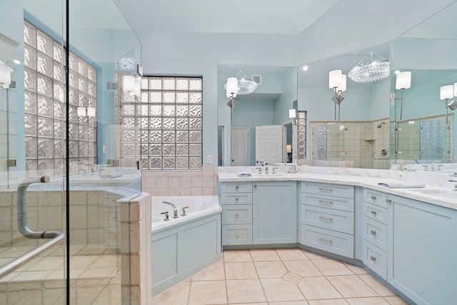 bathroom featuring an inviting chandelier, vanity, tile patterned flooring, and plus walk in shower