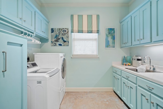 laundry area with cabinets, independent washer and dryer, ornamental molding, and sink