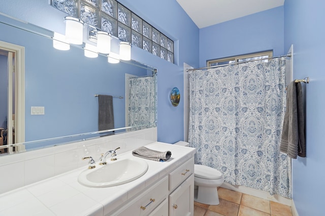 bathroom featuring tile patterned flooring, vanity, and toilet