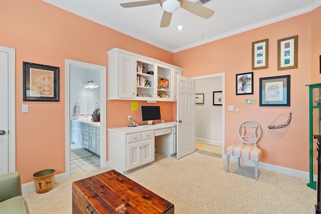 office featuring ornamental molding, light carpet, and built in desk