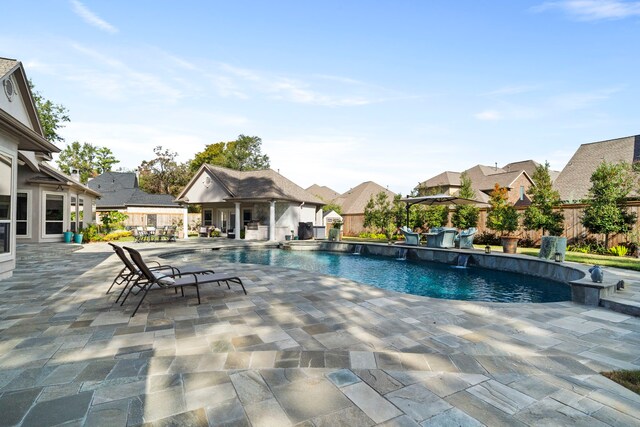 view of pool with a patio area and pool water feature