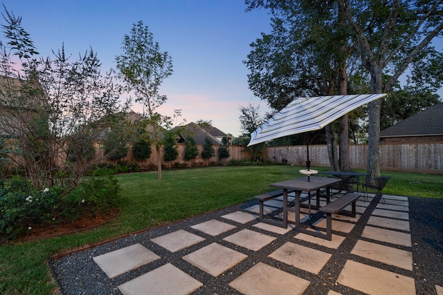 patio terrace at dusk with a lawn