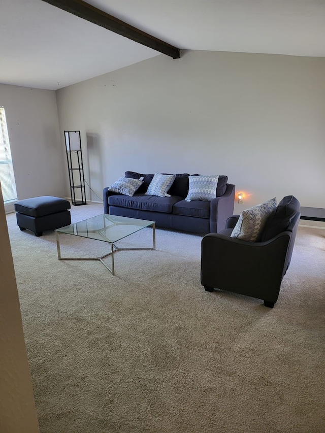 carpeted living room with lofted ceiling with beams