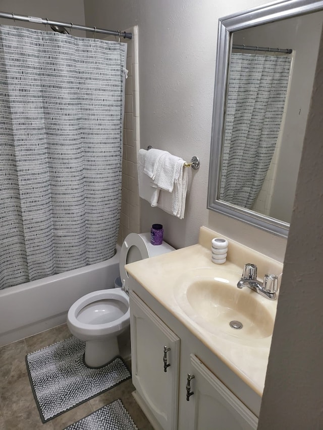 full bathroom featuring tile patterned floors, vanity, toilet, and shower / bath combo with shower curtain