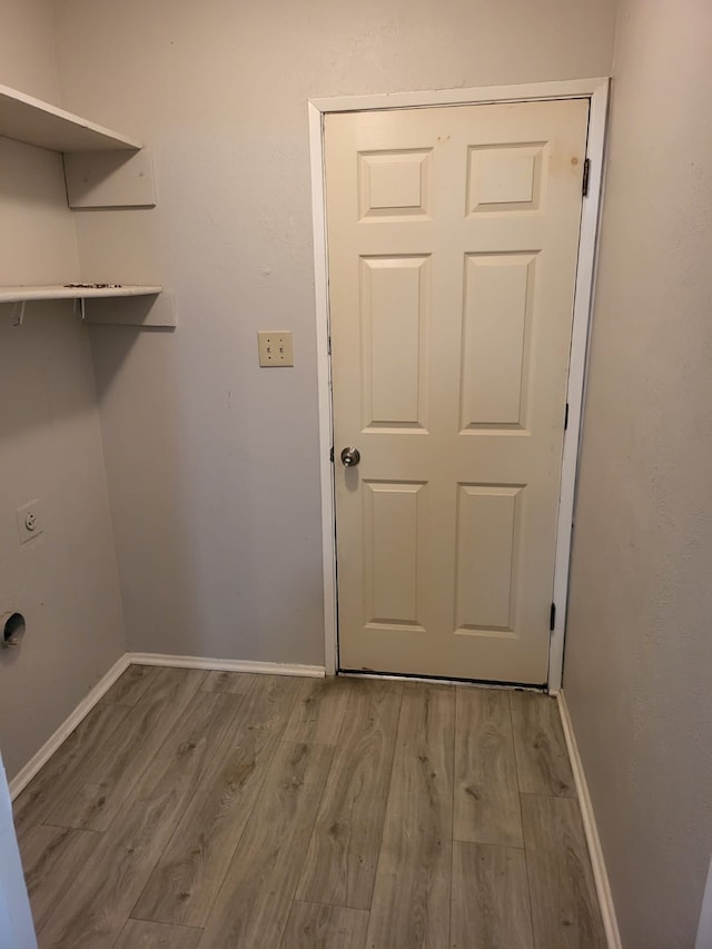 washroom with electric dryer hookup and light wood-type flooring