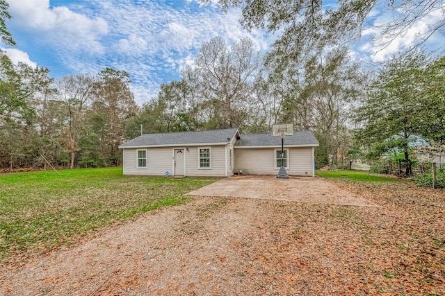 rear view of house featuring a patio area and a yard