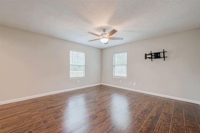 empty room with a textured ceiling, ceiling fan, and dark wood-type flooring