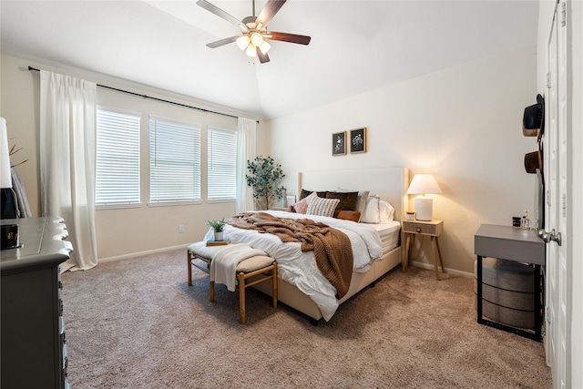 carpeted bedroom with ceiling fan and vaulted ceiling