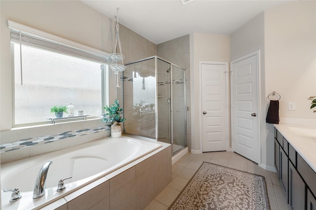 bathroom with tile patterned flooring, vanity, and separate shower and tub