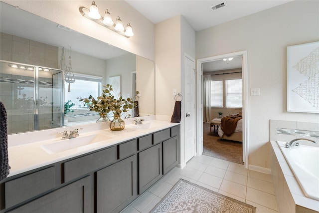 bathroom featuring tile patterned flooring, vanity, and separate shower and tub