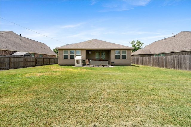 back of house with a lawn, an outdoor living space, and a patio area