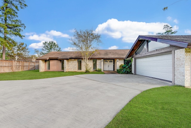 ranch-style home with a front yard and a garage