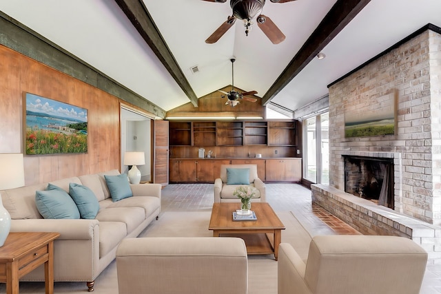 living room featuring lofted ceiling with beams, wood walls, a fireplace, and ceiling fan