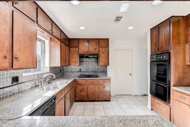 kitchen with decorative backsplash, sink, light tile patterned floors, and black appliances