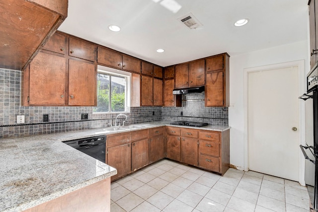 kitchen with light tile patterned floors, sink, backsplash, and black appliances