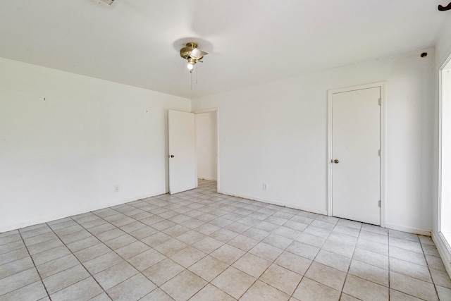 spare room featuring light tile patterned flooring