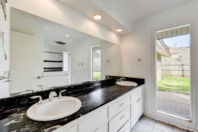 bathroom featuring tile patterned flooring, vanity, and a wealth of natural light