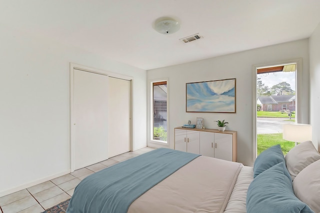 bedroom with a closet and light tile patterned floors