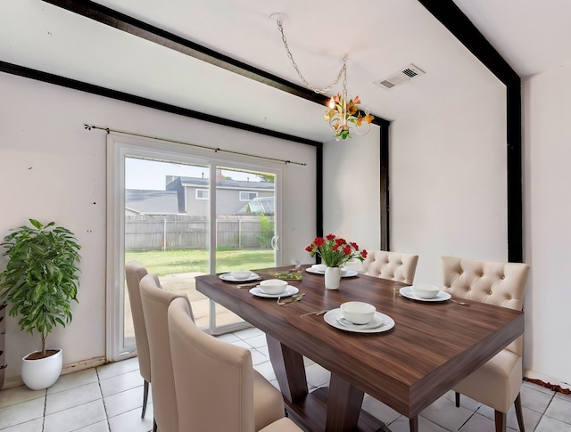 tiled dining space featuring an inviting chandelier