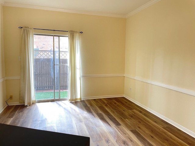 unfurnished room with hardwood / wood-style flooring and crown molding