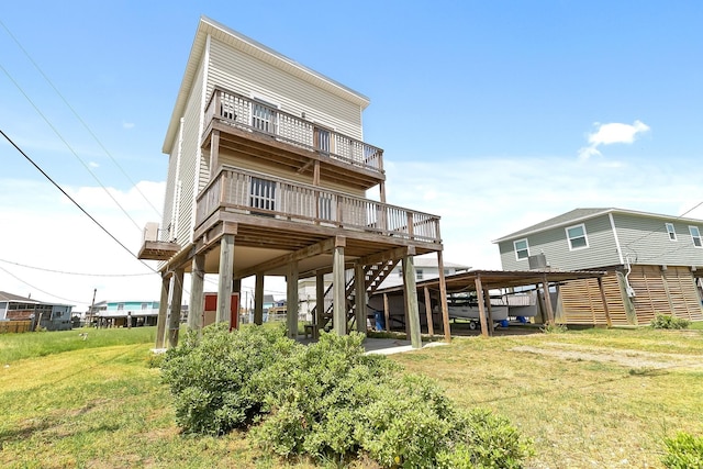 rear view of property with a deck and a lawn