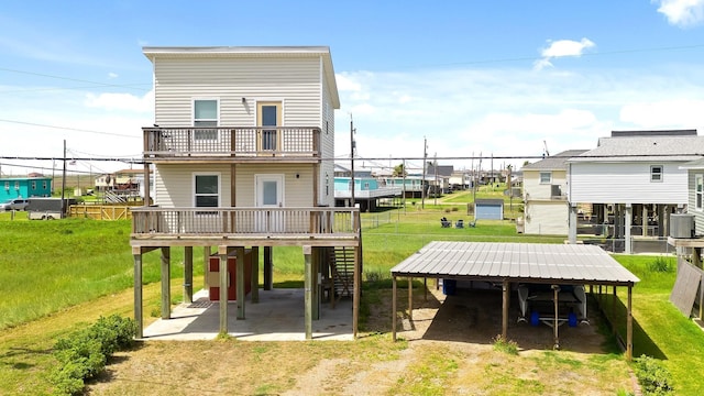 rear view of house featuring a yard and a balcony