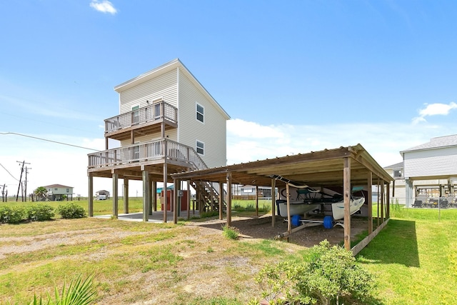 rear view of house with a lawn and a wooden deck