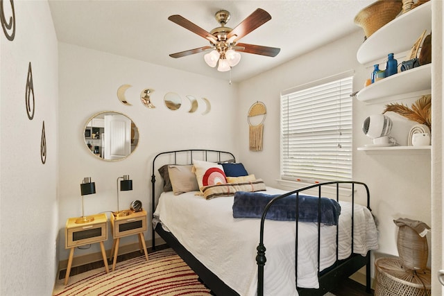 bedroom with hardwood / wood-style floors and ceiling fan