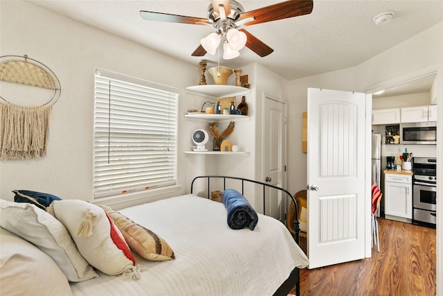 bedroom with ceiling fan and dark hardwood / wood-style flooring