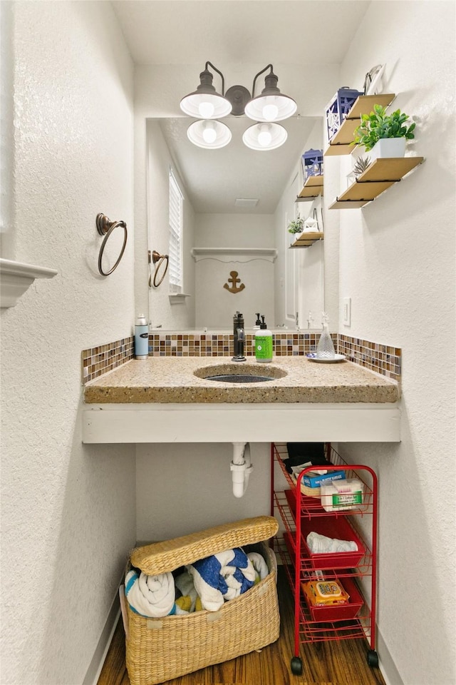 bathroom with hardwood / wood-style floors and sink