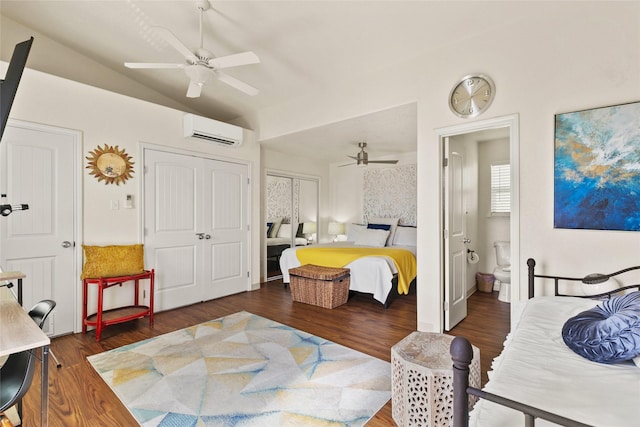 bedroom with connected bathroom, ceiling fan, dark wood-type flooring, a wall mounted AC, and lofted ceiling