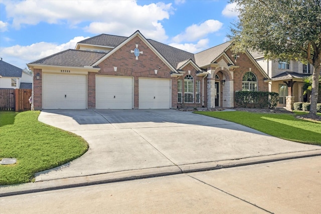 view of front of home with a garage and a front lawn