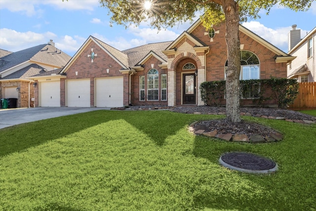 view of front facade with a garage and a front lawn